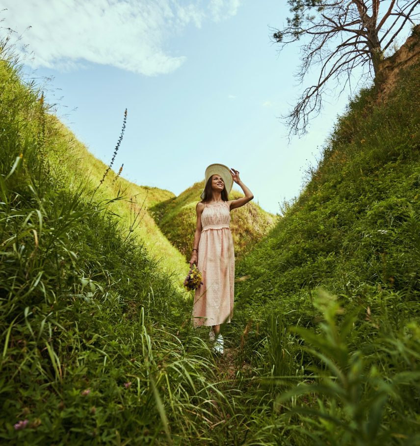 Happy lady enjoying summer walk in the nature